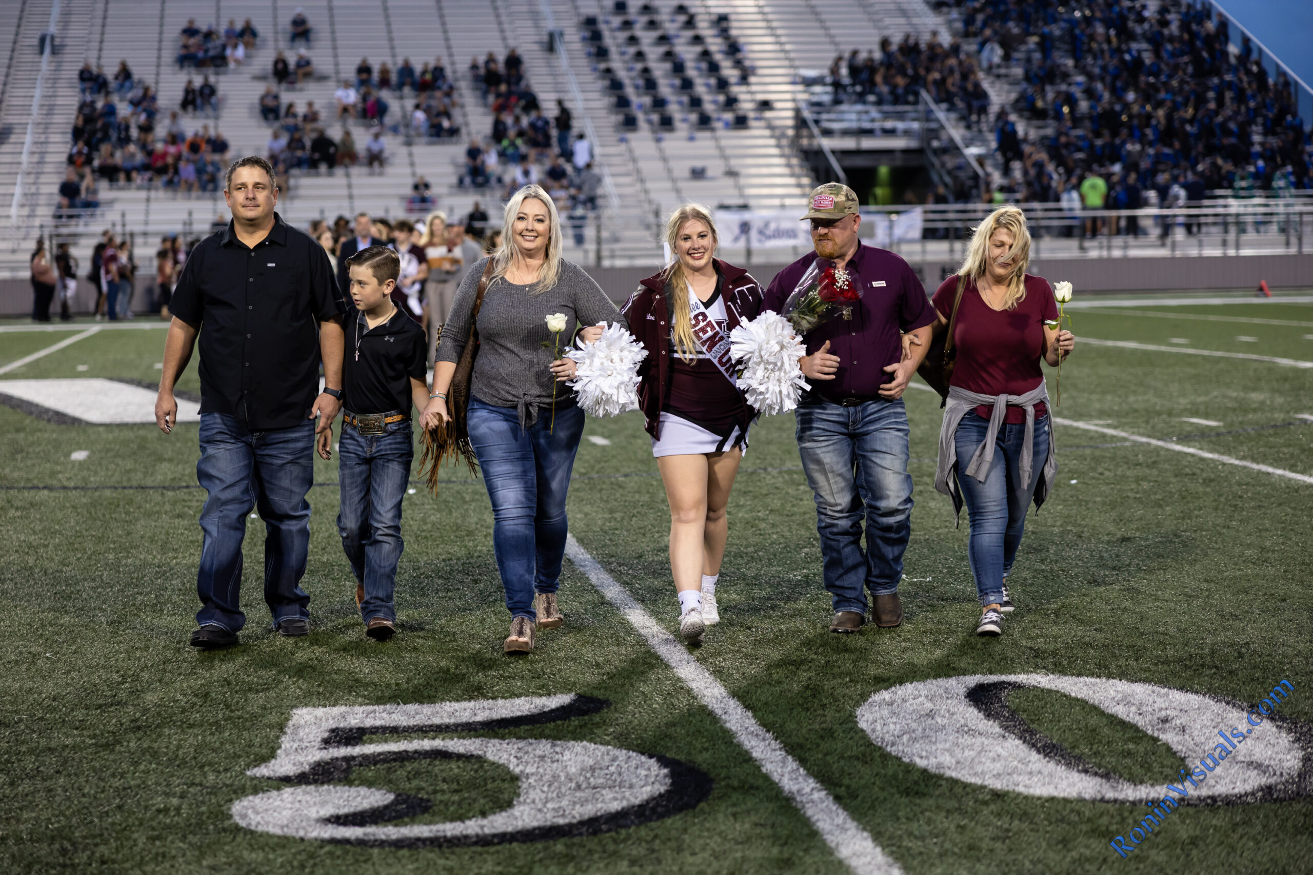 Waller parents are recognized with their senior student as the Bulldog football team hosts Tomball Memorial for the 2022 District 15-6A finale at Waller ISD Stadium. The Bulldogs celebrated senior night as well. (photo by Creighton Holub, © 2022 Ronin Visuals, all rights reserved.)