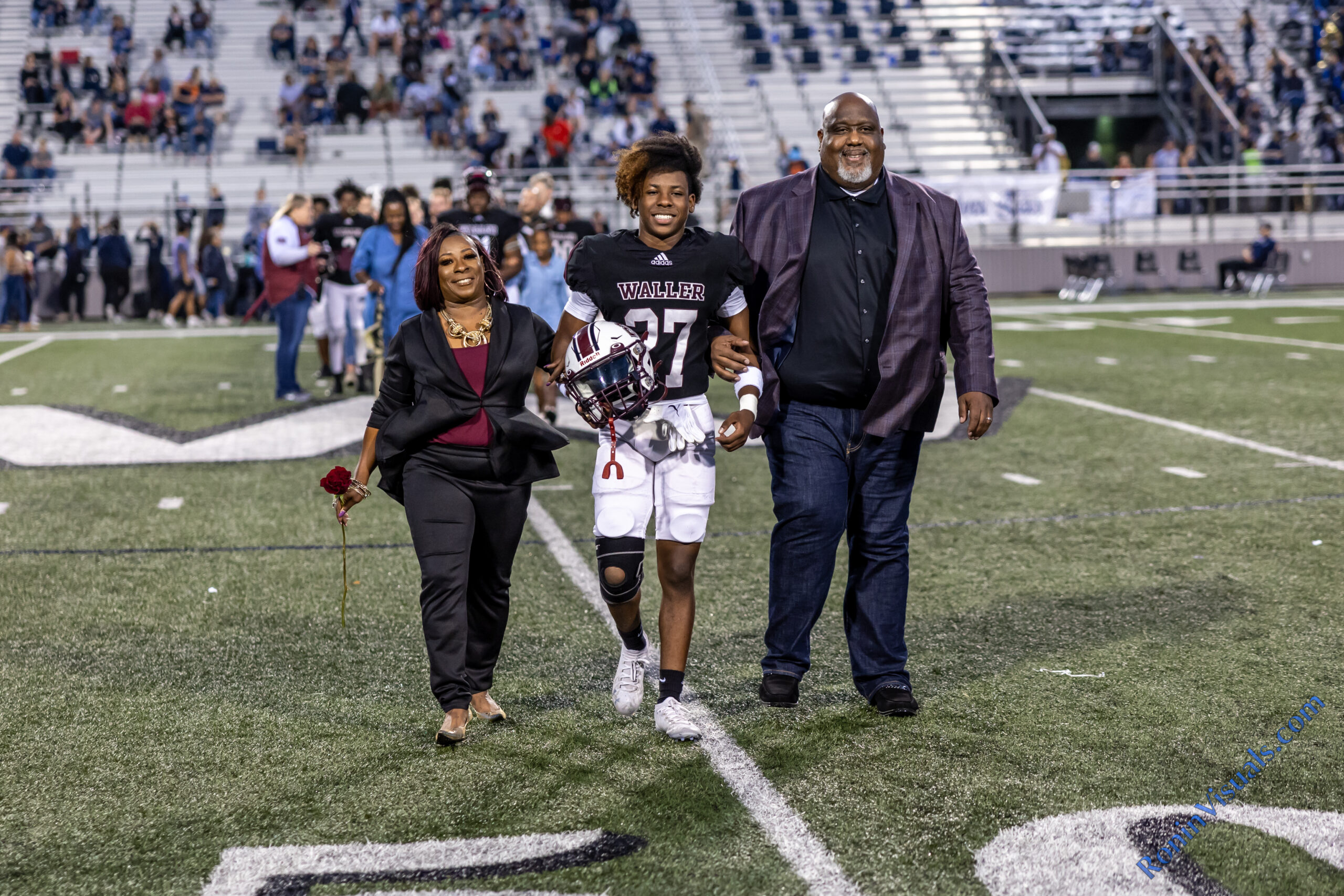 Waller parents are recognized with their senior student as the Bulldog football team hosts Tomball Memorial for the 2022 District 15-6A finale at Waller ISD Stadium. The Bulldogs celebrated senior night as well. (photo by Creighton Holub, © 2022 Ronin Visuals, all rights reserved.)