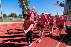 Marcos Cruz gives Macy Moffitt a lift back to the Waller side of the stadium after sharing school spirt with the Klein cheerleaders. The Waller varsity Bulldogs defeated Klein for the team’s first ever district victory in Class 6A, 38-21, at Klein Memorial Stadium on Saturday, Oct. 14, 2023. (Photo courtesy RoninVisuals.com)