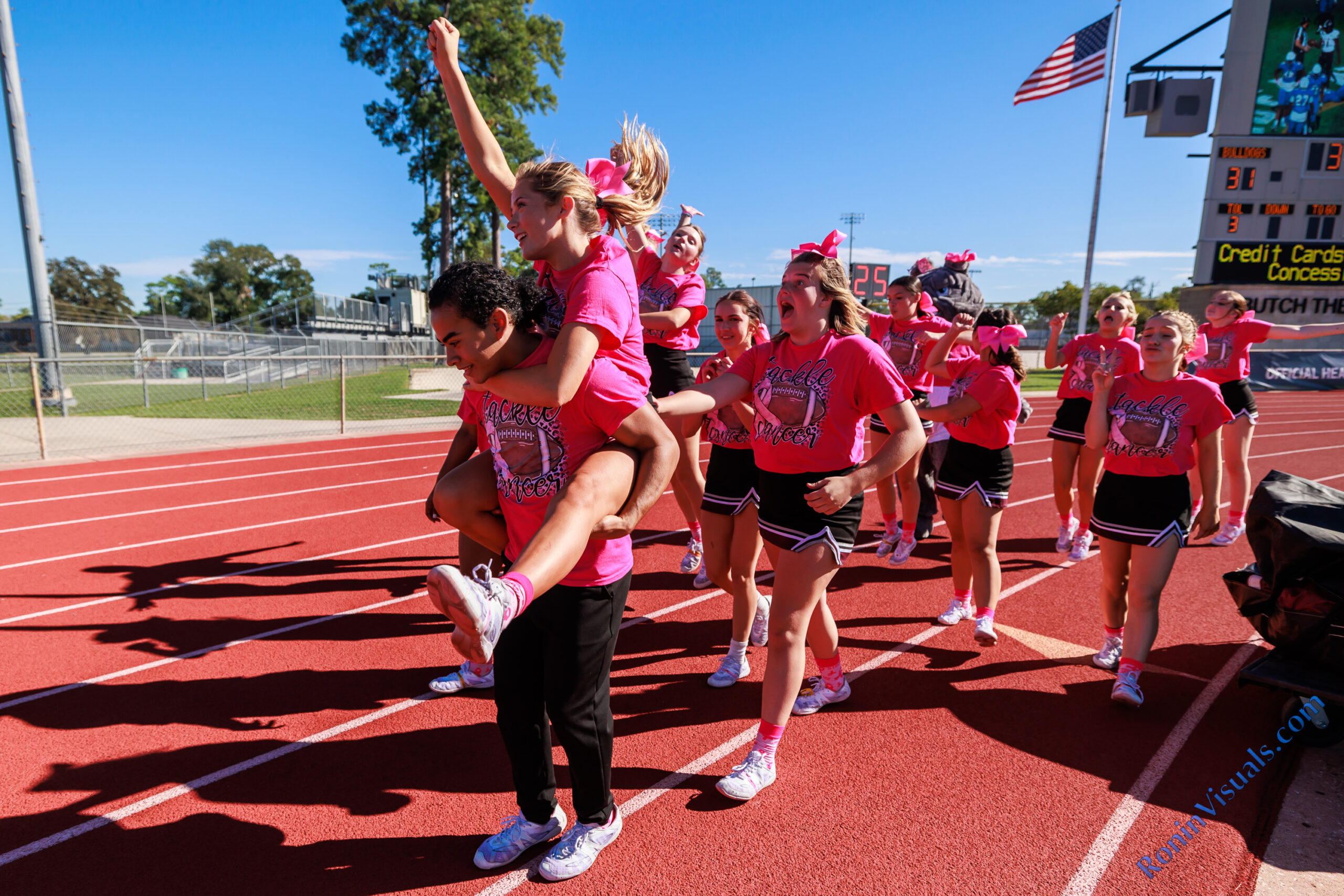 Marcos Cruz gives Macy Moffitt a lift back to the Waller side of the stadium after sharing school spirt with the Klein cheerleaders. The Waller varsity Bulldogs defeated Klein for the team’s first ever district victory in Class 6A, 38-21, at Klein Memorial Stadium on Saturday, Oct. 14, 2023. (Photo courtesy RoninVisuals.com)