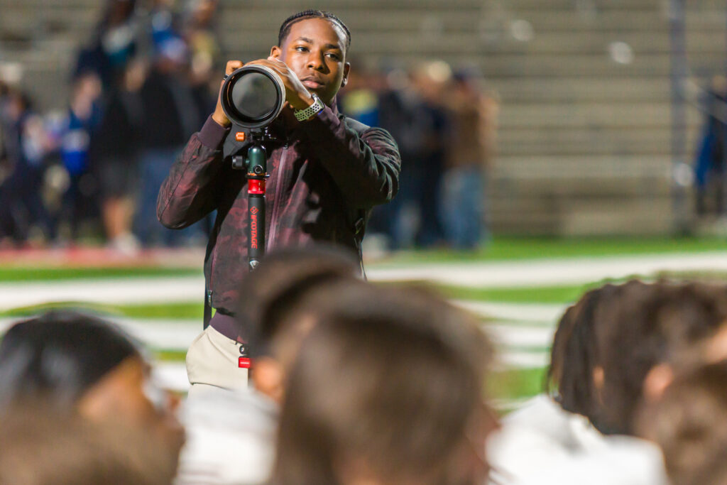 Troy Hubbard scans for his next emotion-driven image at the conclusion of a highly ranked football game. (Photo by Creighton Holub, courtesy RoninVisuals.com)